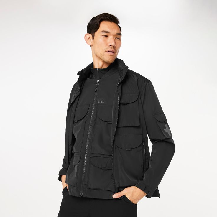 Official FIGS® Outerwear. Get Free Shipping On Orders $50+! | FIGS Mens Black On-Shift Extremes Jacket™ Fall Outdoor Work Outerwear With Multiple Pockets, Black Windbreaker With Cargo Pockets For Fall, Functional Sport Coat For Workwear In Fall, Black Techwear Outerwear For Outdoor Work, Black Cargo Pockets Windbreaker For Fall, Black Fall Windbreaker With Cargo Pockets, Functional Fall Sport Coat For Workwear, Black Outdoor Outerwear With Multiple Pockets, Outdoor Outerwear With Side Pockets And Stand Collar