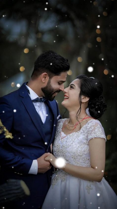 a bride and groom standing close together in front of christmas lights