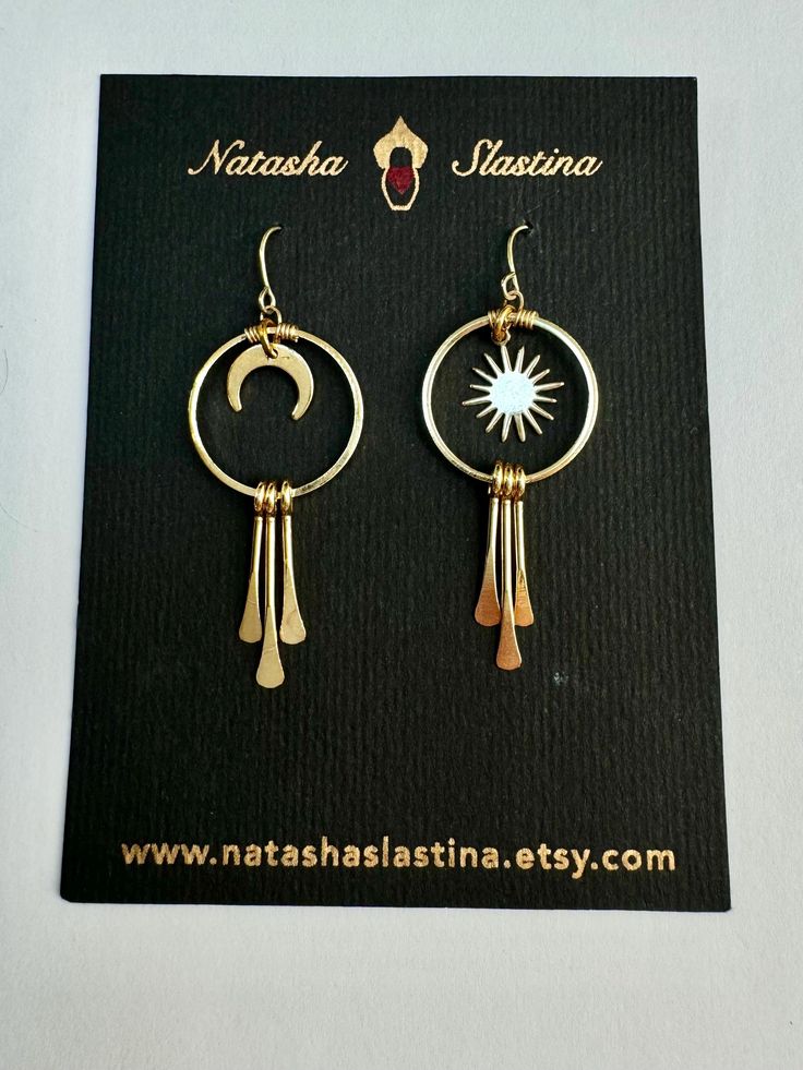 Elevate your style with these stunning sun and moon earrings, perfect for both everyday wear and special occasions. This versatile pair effortlessly complements any outfit, and the sun, moon, and golden dangles catch the light beautifully with every move. A truly must-have accessory, these earrings are sure to make a statement! Celestial Dangle Earrings For Everyday, Celestial Style Dangle Earrings For Everyday, Everyday Celestial Dangle Earrings, Celestial Sun And Moon Dangle Jewelry, Bohemian Gold Hoop Earrings With Moon Charm, Gold Celestial Earrings With Sun And Moon Design, Elegant Dangle Earrings With Sun Design, Summer Gold Jewelry With Sun And Moon Design, Elegant Sun Design Dangle Earrings