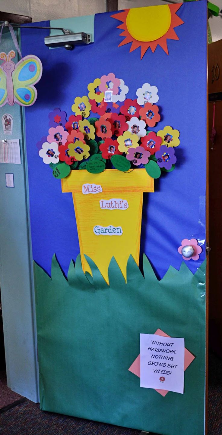 a classroom door decorated with flowers and butterflies