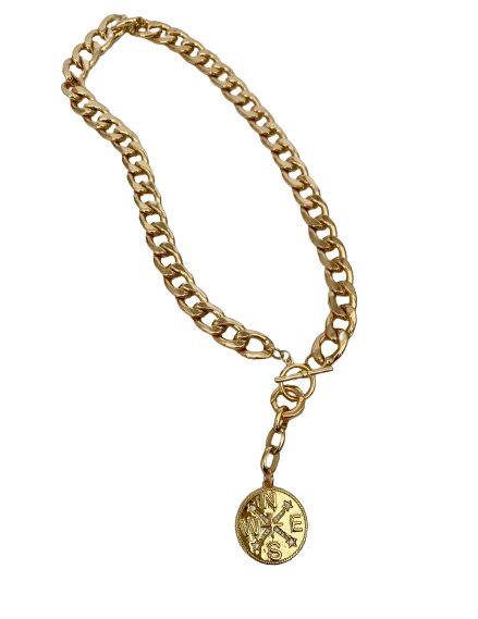 This snake chain necklace commands attention with its bold design and luxurious appeal. Crafted from gleaming gold, each link in the chain is substantial, exuding a sense of opulence and strength. At its center lies the focal point of the piece: a large gold charm shaped like a compass rose, with distinct north, south, east, and west directions. The charm is intricately detailed, its smooth surface catching the light and casting a warm, radiant glow. Completing the necklace is a gold toggle clasp, adding both functionality and style to the piece. The total length is 20 inches with the clasp right at 18 inches. When worn, this statement necklace becomes more than just an accessory; it becomes a symbol of confidence, sophistication, and timeless elegance. Its weight on the neckline serves as Gold Charm Necklace With Chunky Chain For Gifts, Gold Medallion Jewelry With Cable Chain, Gold Medallion Charm Necklace With Cable Chain, Elegant Metal Toggle Necklace With Cable Chain, Gold Charm Necklace With Round Pendant And Cable Chain, Gift Pendant Chain Necklace With Chunky Chain, Gift Chunky Chain Necklace With Pendant, Elegant Gold-plated Pendant Toggle Necklace, Elegant Gold Plated Toggle Pendant Necklace