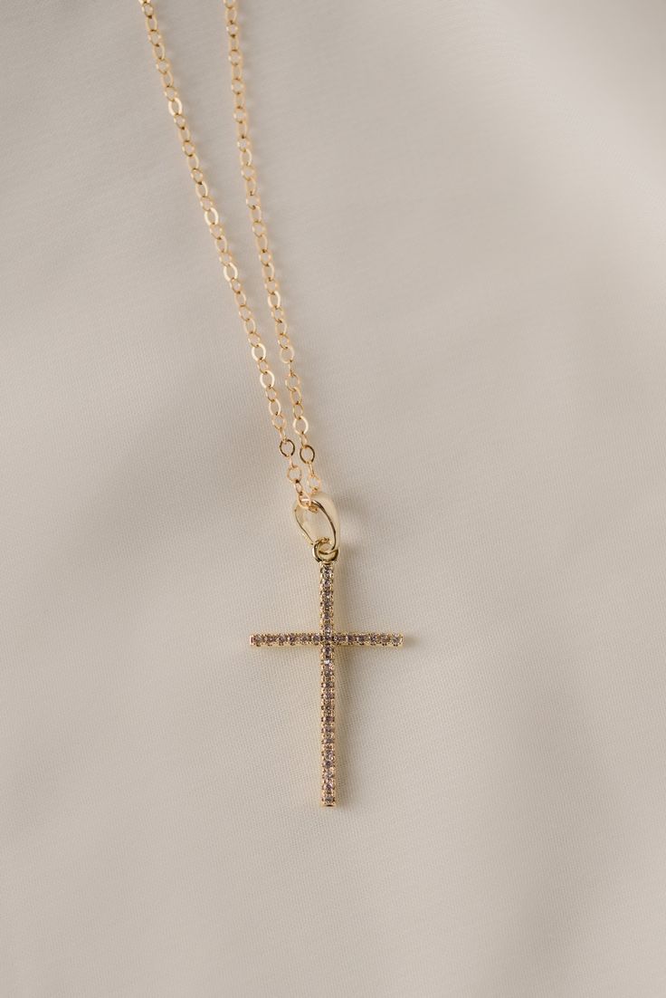 Our popular vertical cross pendant is a subtle statement to add sparkle to any look. split 18k gold-filled vertical cross pendant + CZ accent stones Your choice of chain length (16", 18", or 20") All materials are lead & nickel free Handmade with love by Luna & Jade in the U.S. Luxury Clavicle Chain With Cross Pendant, Cheap Adjustable Cross Pendant Necklace, Affordable Stainless Steel Cross Pendant Necklace, Cheap Yellow Gold Cross Necklace, 14k Gold Filled Cross Pendant Jewelry With Adjustable Chain, Everyday 14k Gold Filled Cross Pendant Necklace, 14k Gold Filled Cross Pendant Necklace, 14k Gold-filled Gold Cross Pendant Necklace, Gold Cross Pendant Necklace In 14k Gold Filled