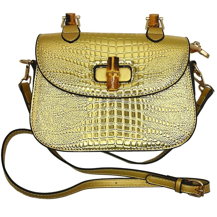 a gold purse with an alligator skin pattern on the front and shoulder strap, attached to a brown leather handbag