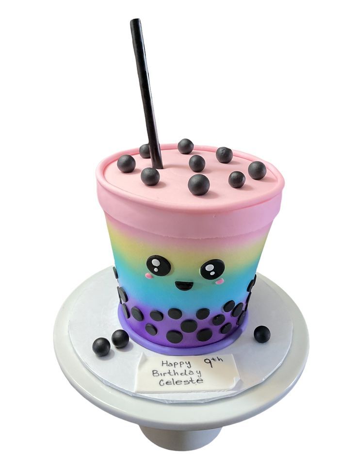 a cupcake cake with a straw sticking out of it's top on a plate