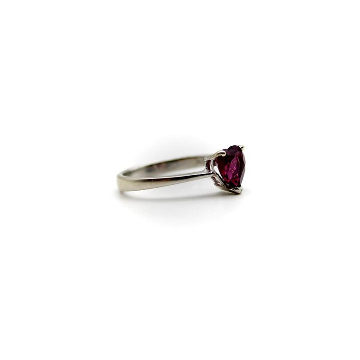 This is part of Chairish’s Fine Jewelry assortment.  This 18k white gold ring features a beautifully coloured heart-shaped garnet. The garnet is a saturated deep magenta, with facets that sparkle in many different hues of pink and red. It is prong set with three prongs; the back of the carriage or underside of the ring is a heart shape as well, for an adorable added touch. A wonderful sweetheart ring , this is the perfect gift to show someone your love or your self love.  The rings weighs 2.9 gr Classic Heart-shaped Ruby Ring For Formal Occasions, Classic Heart-shaped Ruby Ring, Heart Shaped Solitaire Ring For Formal Occasions, Formal Fine Jewelry Heart Ring With Birthstone, Formal Heart Shaped Solitaire Ring, Formal Heart-shaped Solitaire Rings, Elegant Pear-shaped Rings For Valentine's Day, Formal Heart Ring With Birthstone, Classic Heart Cut Ruby Promise Ring