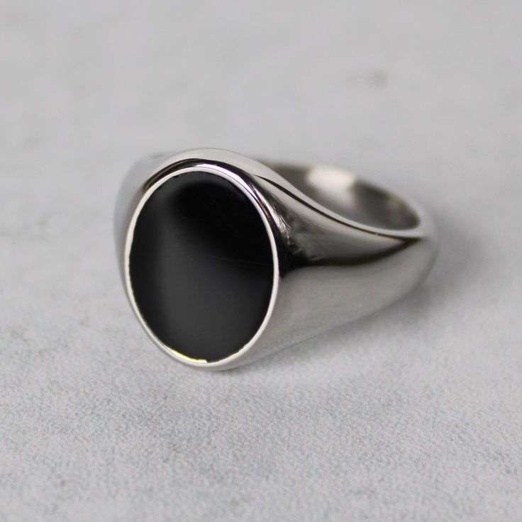 Premium Stainless Steel Color: Steel Black Front Is Enamel 16mm X 12mm Width Available Sizes 7 / 8 / 9 / 10 / 11 / 12 (View Size Guide Or Choose Your Us Ring Size) Safe In Water Classic Silver Stainless Steel Signet Ring, Silver Oval Signet Ring For Everyday, Everyday Black Signet Ring With Polished Finish, Classic Oval Stainless Steel Rings, Elegant Silver Stainless Steel Signet Ring, Everyday Black Sterling Silver Signet Ring, Formal Oval Stainless Steel Jewelry, Sleek Silver Rings With Polished Finish, Elegant Black Stainless Steel Signet Ring