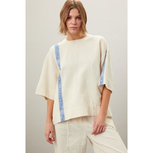 Off-white cotton (51% Cotton, 49% Linen). Top. 3/4 Sleeves. Crewneck.  Back button closure. 28" from shoulder to hemline. Imported. White Half Sleeve Top For Work, White Half Sleeve Workwear Top, Spring Cotton T-shirt For Daywear, Cream Linen Tops For Daywear, Cream Cotton Top For Daywear, Cotton Top With 3/4 Sleeves For Spring, Oversized T-shirt With 3/4 Sleeves For Spring, Relaxed Fit Tops With 3/4 Sleeve For Daywear, Relaxed Fit 3/4 Sleeve Tops For Daywear