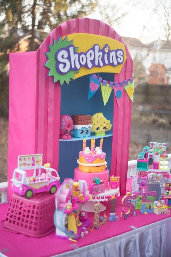 a pink table topped with lots of toys