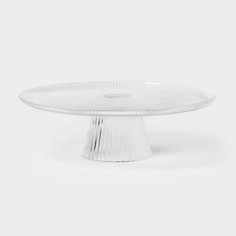 an empty glass cake plate on a white background