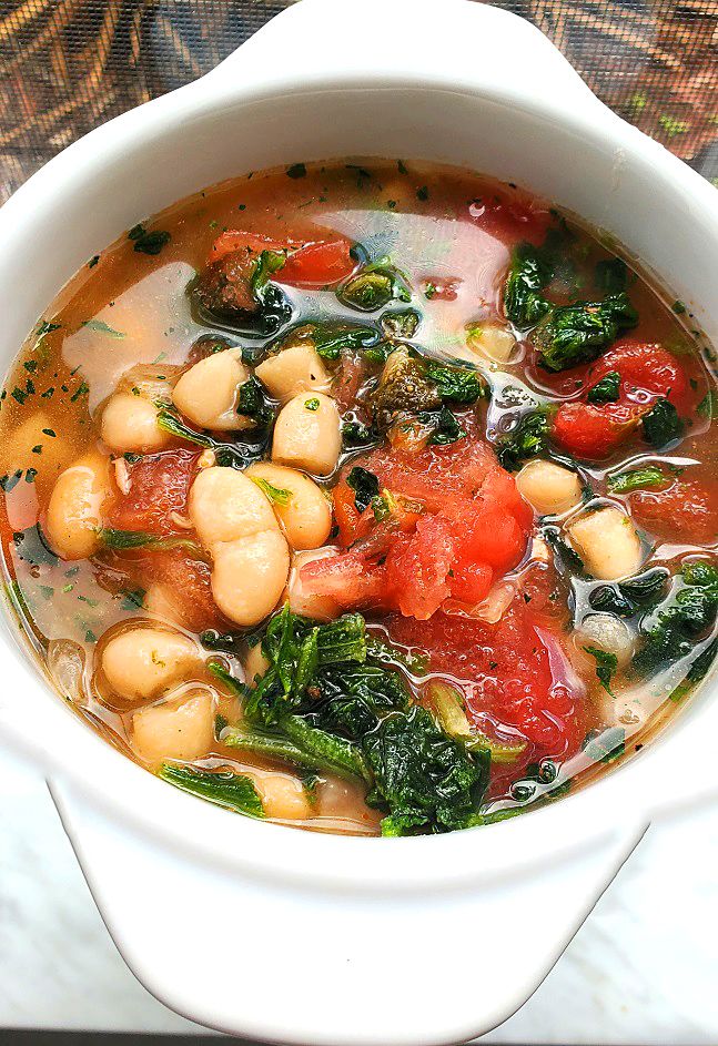 a white bowl filled with soup and vegetables