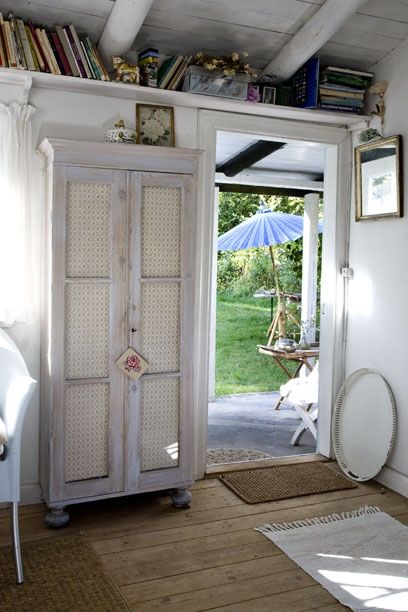 an open door leading into a room with bookshelves