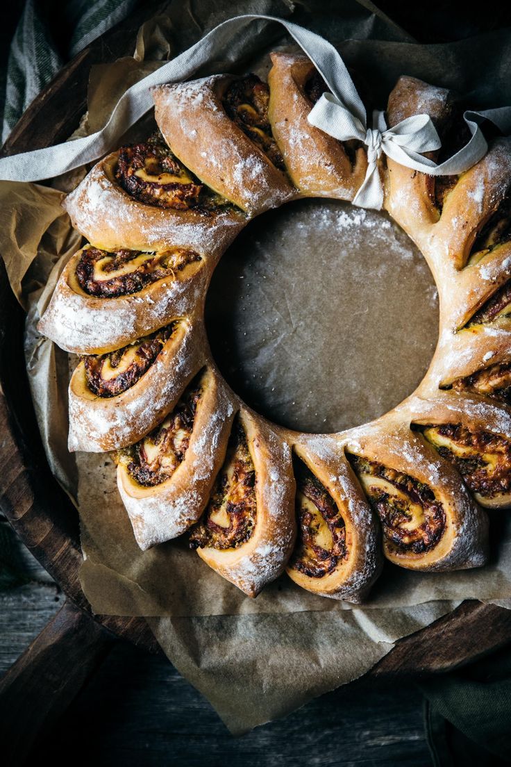 a cinnamon roll wreath on top of wax paper