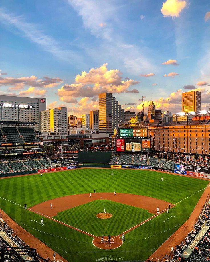 a baseball field with the city skyline in the background