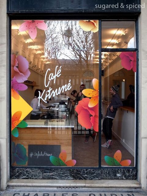 the front window of a cafe with flowers painted on it