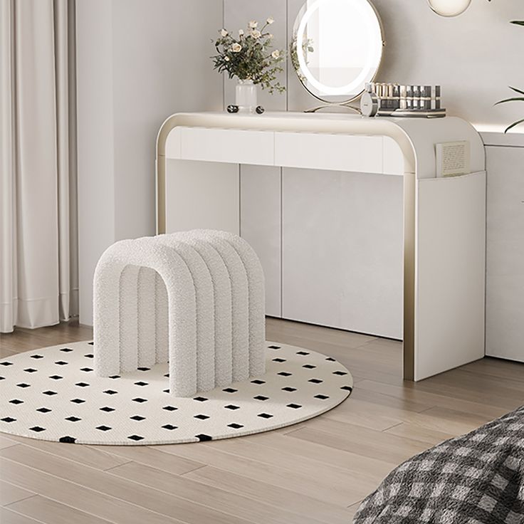 a white table with four stools and a mirror on the wall in front of it