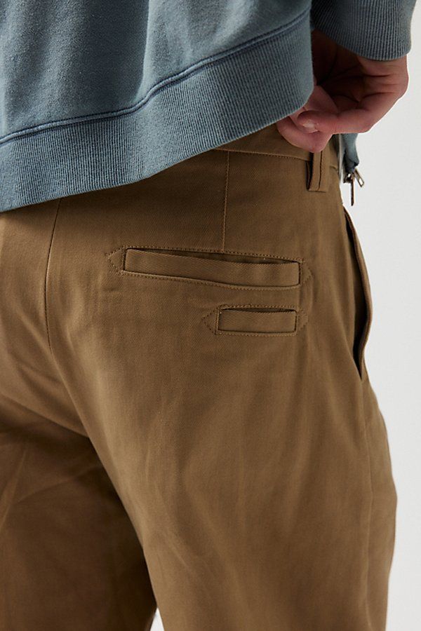 Essential chino pants in a relaxed & baggy skate fit silhouette. Chinos in 100% cotton with a straight leg fit. Features UO Turbo baggy skate chino Relaxed fit chino pants Mid rise waist Zip fly; button closure Straight leg openings Content + Care 100% Cotton Machine wash Imported Size + Fit Model in Slate is 6’1.5" and wearing size 32/32 Measurements taken from size 32/32 Rise: 11" Inseam: 32" Leg opening: 9" | Urban Outfitters UO Turbo Baggy Skate Chino Pant in Tan, Men's at Urban Outfitters Streetwear Cargo Pants With Welt Pockets And Straight Leg, Relaxed Fit Chino Cotton Twill Pants With Cargo Pockets, Streetwear Bottoms With Welt Pockets And Straight Hem, Classic Cargo Pants With Welt Pockets For Streetwear, Classic Cargo Pants For Streetwear With Straight Hem, Classic Cargo Pants With Straight Hem For Streetwear, Classic Straight Hem Cargo Pants For Streetwear, Urban Cotton Work Pants With Patch Pockets, Streetwear Chinos With Hip Pockets, Tapered Leg