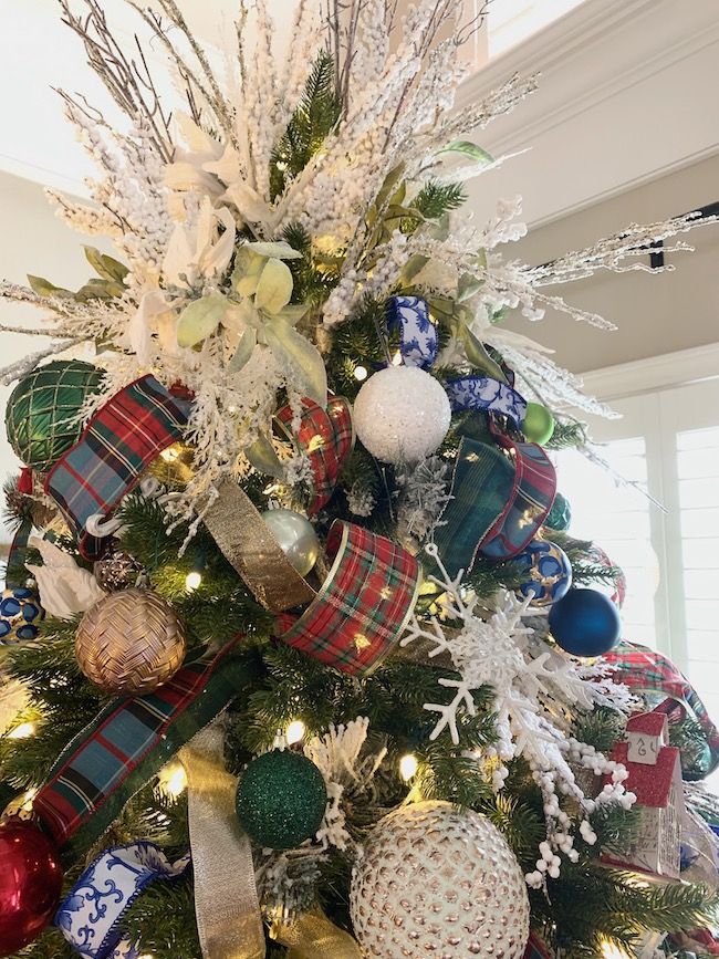 a christmas tree decorated with ornaments and ribbons