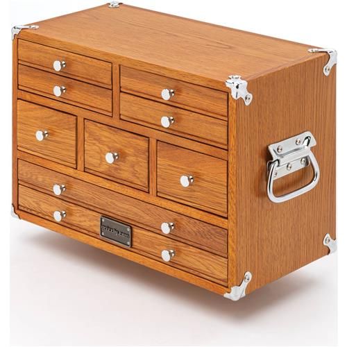 a wooden chest with many drawers and handles on it's sides, in the shape of a trunk