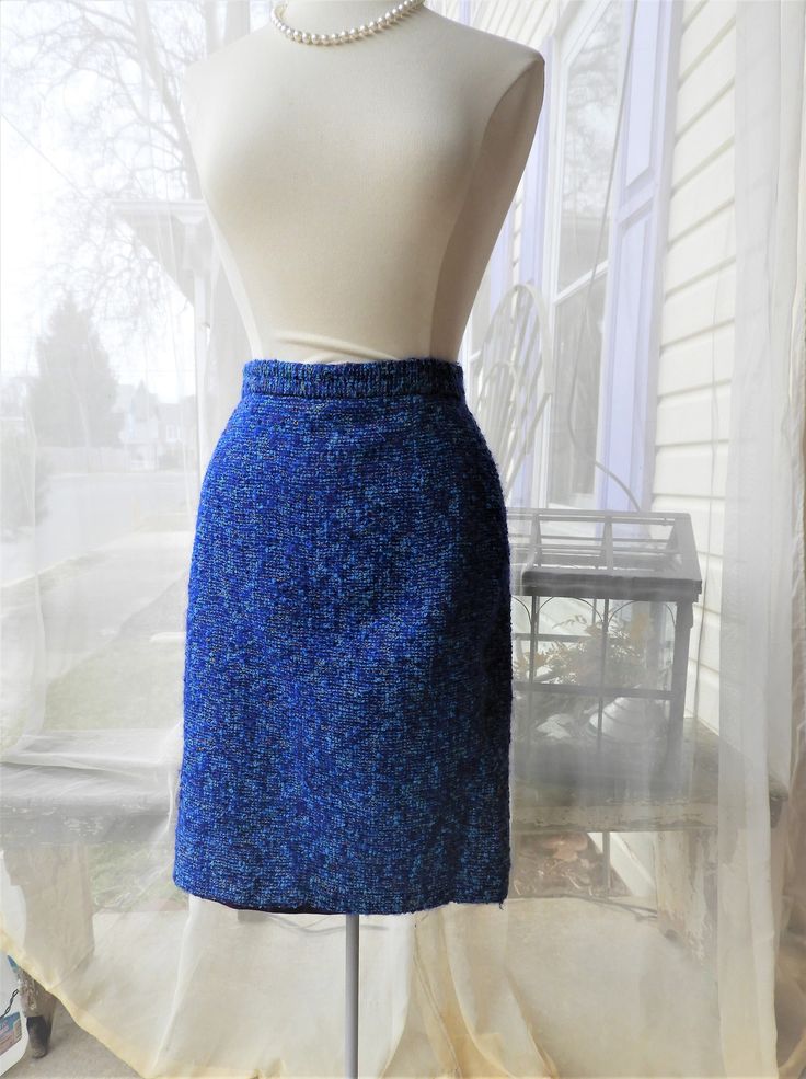 "Vtg 1970's  Ladies Blue Wool Skirt|Vtg French Boucle Blue Pencil Skirt|Vtg Terry Retro Ladies Skirt sz S I love this skirt!  It is a vintage 1970's wool boucle piece by Terry.  Made in France, this skirt is great quality with a mix of colours in the fabric.  I call boucle \"nubby wool\".  I don't see any of this fabric being made anymore unfortunately.  The blues here are so bright and vibrant!  The style is a pencil or broomstick, very popular in the 1970's. There is a kickpleat in back here a Blue Retro Mini Skirt For Spring, Retro Blue Lined Skirt, Retro Fitted Blue Mini Skirt, Retro Blue Mini Skirt, Vintage Blue Lined Skirt, Blue Lined Vintage Skirt, Vintage Blue Skirt, Retro Blue Lined Skirt Bottoms, Vintage Blue Fitted Bottoms