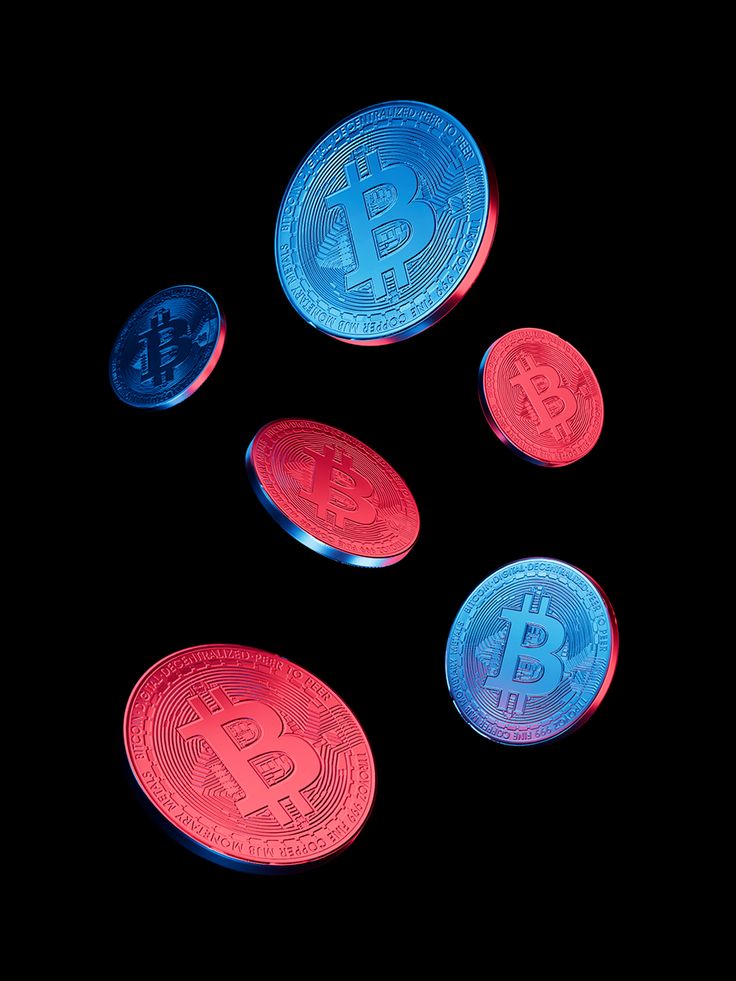 three lit up bitcoins sitting next to each other on top of a black surface