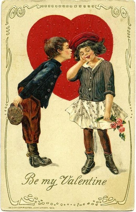 an old valentine card with two children kissing