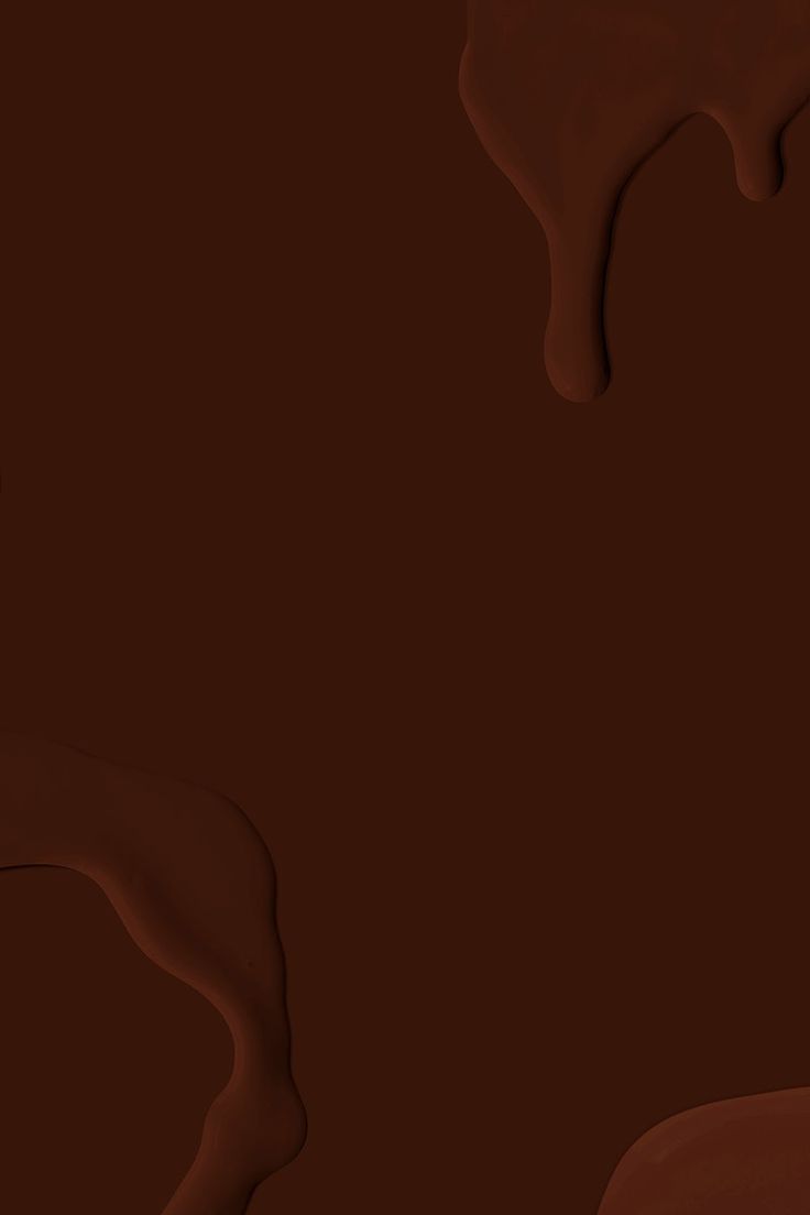 chocolate flowing down the side of a piece of cake with icing on it, in front of a dark background