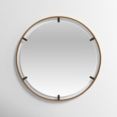 a round mirror hanging on the wall