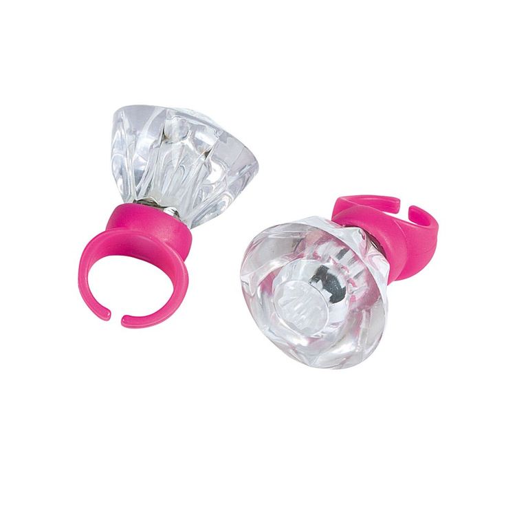 two pieces of plastic with pink handles and clear glass in the middle, on a white background