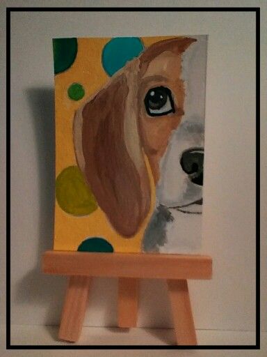 a small easel with a painting of a dog on it