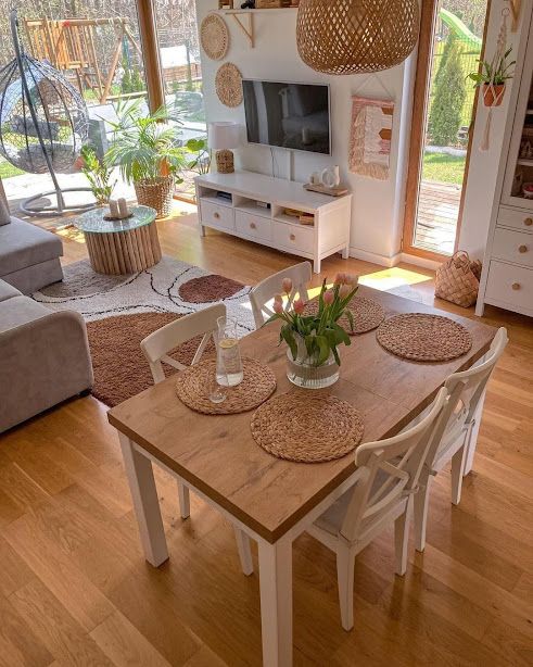 a living room filled with furniture and a wooden table in front of a tv set