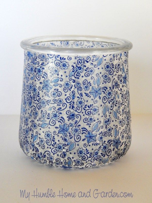 a blue and white planter sitting on top of a table