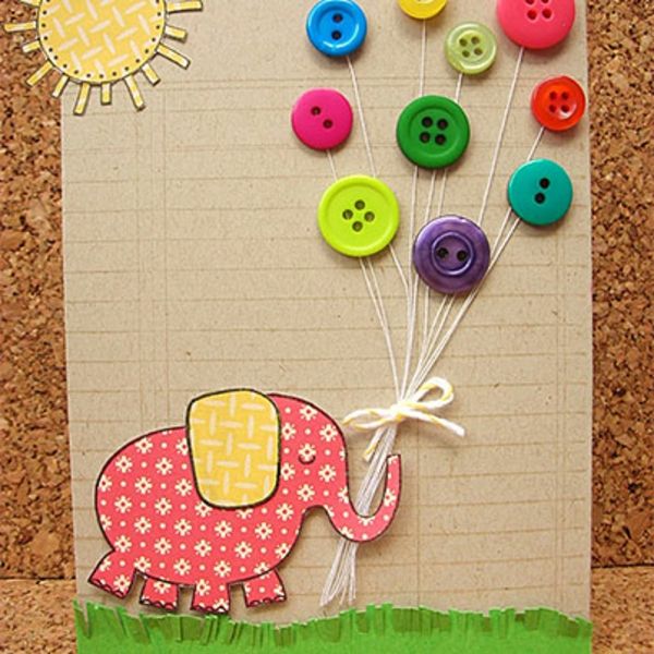 a card with buttons attached to it and an elephant in the grass holding onto balloons