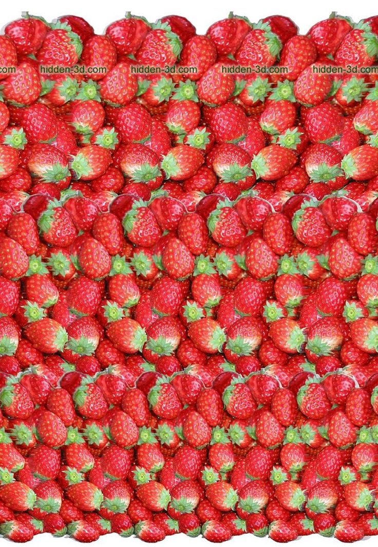 a large pile of strawberries with green leaves