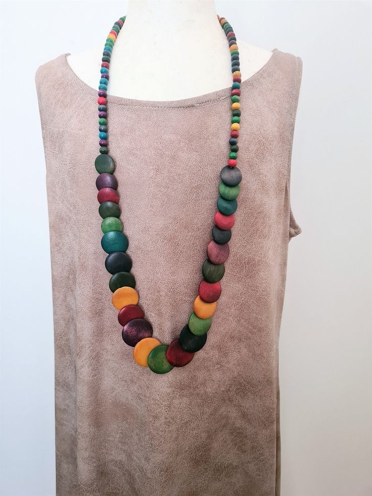 "Multi Colored Long Boho Wood Vintage Necklace. Vintage Wood Bohemian Necklace Long Necklace. Rainbow Wood Vintage Long Wood Necklace Such a pretty piece comprised of Vintage Rainbow Wood and Disc Multi Colored Rainbow Wood Beads. Beautiful Necklace! Necklace is 35 inches long Don't miss out! *If you have have any questions regarding this item, please hit the \"Ask a Question\" button next to the price and I will get back to you within 24 hours:-) We pride ourselves on 100% customer service, ple Wooden Beads Round Necklace For Beach, Bohemian Rainbow Beads For Jewelry Making, Rainbow Bohemian Beads For Jewelry Making, Bohemian Rainbow Necklaces With Colorful Beads, Bohemian Rainbow Necklaces With Natural Stones, Bohemian Rainbow Gemstone Beads Necklace, Bohemian Rainbow Beaded Jewelry, Unique Multicolor Wooden Beads Necklaces, Artisan Multicolor Necklaces With Large Beads