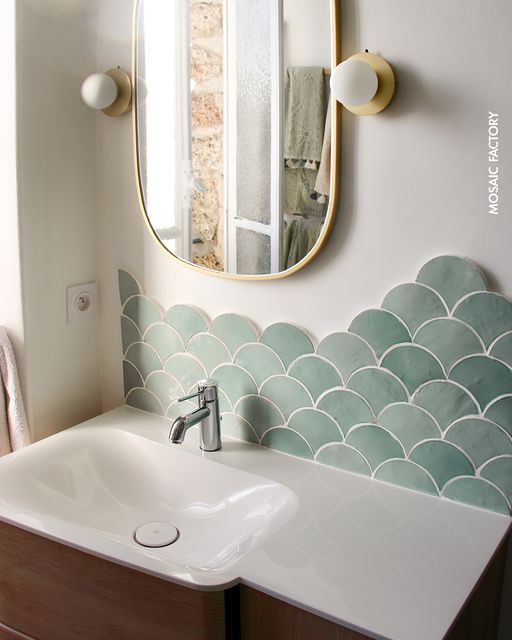 a bathroom sink with a mirror above it