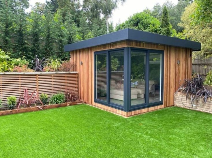 a garden room with artificial grass in the backyard