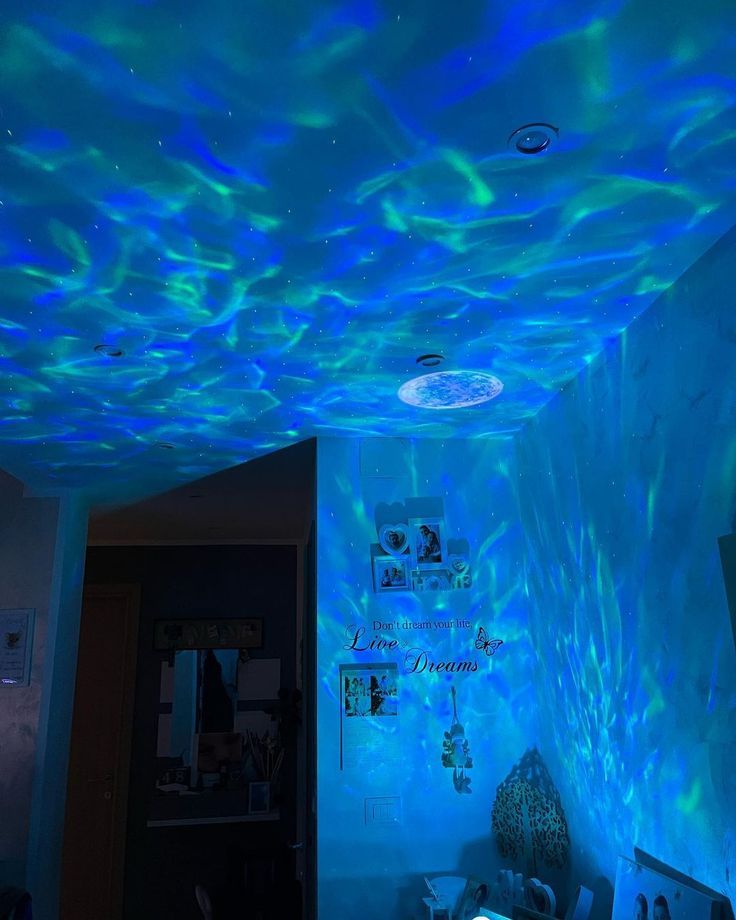 the ceiling is covered in blue lights and fish tank like material that looks like water