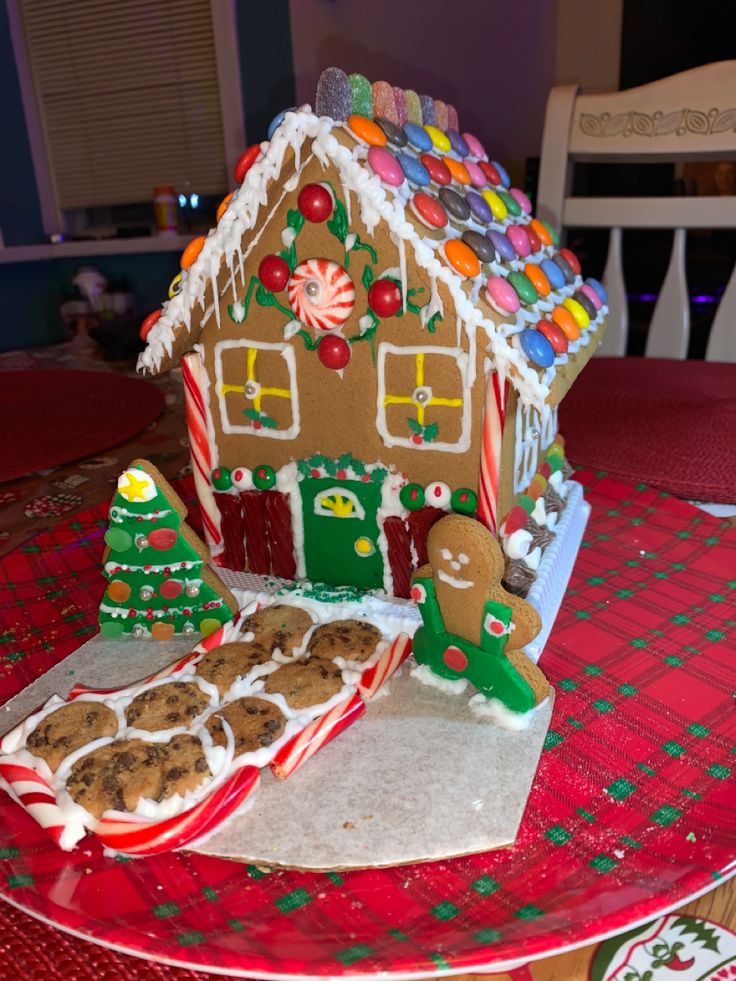 a gingerbread house on a table with cookies