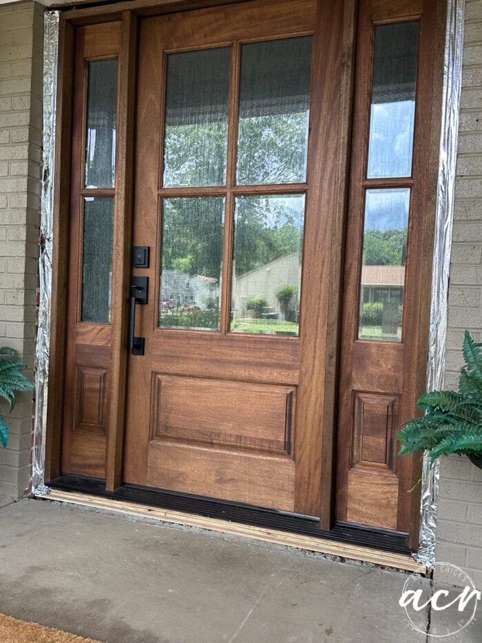 the front door is made of wood and glass