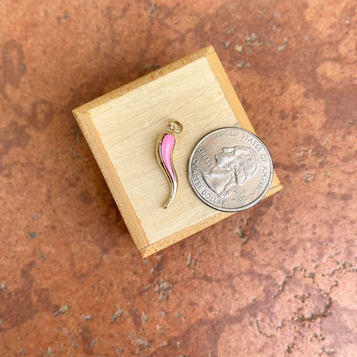 14KT yellow gold Corno/ Cornicello Italian Horn pendant charm with pink enamel. You can wear this pendant TWO WAYS! Wear the front side with the pink or wear it on the back with a polished-gold finish! Length: 23mm not including bail Width: 5.5mm Weight: 1.1 grams Hollow + Lightweight Stamped 14k on inside of bail Can fit up to 3.5mm wide chain No chain included Reversible pendant Gold Enamel Round Pendant Charms, Pink Gold Pendant Jewelry With Charms, Pink Pendant Jewelry With Charms, Yellow Gold Enamel Charms For Gift, Pink Pendant Necklace In Enamel, Pink Enamel Pendant Necklaces, Pink Enamel Heart Pendant Jewelry, Pink Enamel Necklaces With Charms, Pink Enamel Jewelry With Charms