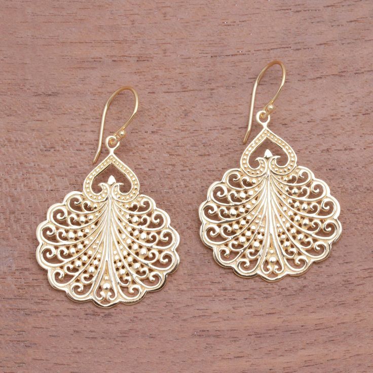 Fanning out like a peacock's tail handcrafted openwork designs in 18k gold plated sterling silver fill these Balinese dangle earrings. Ari Gunawan creates this elegant accessory. Elegant Dangle Jewelry With Peacock Design, Elegant Peacock Design Dangle Jewelry, Elegant Peacock Design Chandelier Earrings, Peacock Design Dangle Chandelier Earrings, Elegant Dangle Earrings With Peacock Design, Elegant Peacock Design Dangle Earrings, Elegant Sterling Silver Earrings With Peacock Design, Elegant Peacock Design Chandelier Earrings For Festive Occasions, Elegant Festive Chandelier Earrings With Peacock Design