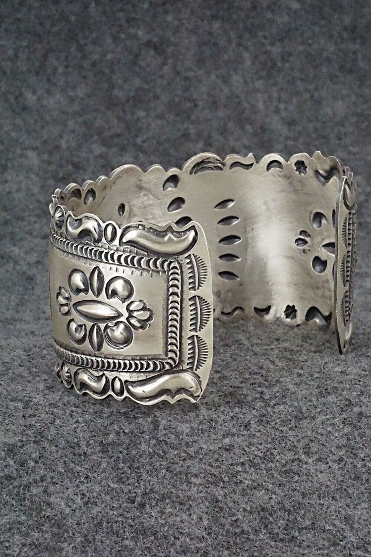 This stunning and intricate sterling silver bracelet was made by Navajo silversmith Eugene Charley. The inside is signed and stamped sterling.Size: 6" (will fit up to a 7 3/8" wrist)Gap: 1 3/8"Width: 1 1/2"Free shipping on all orders! We ship with USPS and always include tracking. All orders ship within a day of payment.Returns are accepted up to 30 days after you receive your order. Just send us a message. Our shop offers cash back or store credit. The item must be returned in new condition. Adjustable Sterling Silver Bracelet With Intricate Design, Bohemian Sterling Silver Cuff Bracelet, Adjustable Bohemian Sterling Silver Bracelet With Intricate Design, Unique Adjustable Sterling Silver Bracelet With Intricate Design, Unique Adjustable Etched Sterling Silver Bracelet, Adjustable Ornate Sterling Silver Bangle, Ornate Antique Silver Sterling Bracelets, Unique Etched Adjustable Sterling Silver Bracelet, Bohemian Sterling Silver Bracelet With Oxidized Finish