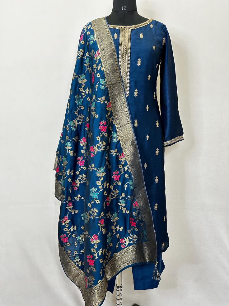 Silk Blend Navy Blue Embroidered Zari Straight Kurta With Trousers and Dupatta Indian Wedding Wear Salwar Kameez / Indian Wedding Dress / Plus Size Cotton Kurta Dress Traditional Indian Wear / Salwar Kameez Dupatta / Kurti Palazzo Set The set contains: 1 Straight Kurta 1 Trousers 1 Dupatta Kurta: The Navy blue straight Kurta has a round neck design with zari work details in front. The Kurta measures till calf length and has straight hemline. Sleeve length :  3/4 Sleeves Sharara :  Solid trousers Blue Silk Kurta With Floral Embroidery, Anarkali Kurta With Floral Embroidery For Celebration, Floral Embroidered Kurta For Eid Celebration, Blue Floral Embroidered Anarkali Churidar, Blue Floral Embroidered Unstitched Suit For Wedding, Blue Anarkali Churidar With Floral Embroidery, Fitted Blue Sharara With Floral Embroidery, Blue Floral Embroidered Churidar For Diwali, Party Dupatta With Floral Embroidery For Transitional Season