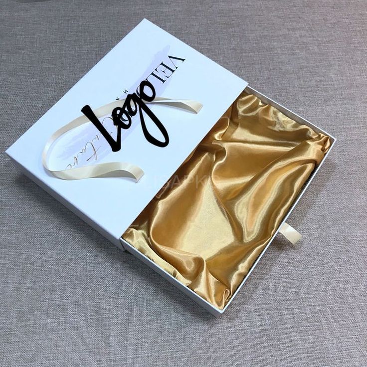 an open white box with gold foil on the bottom and inside that says vegan