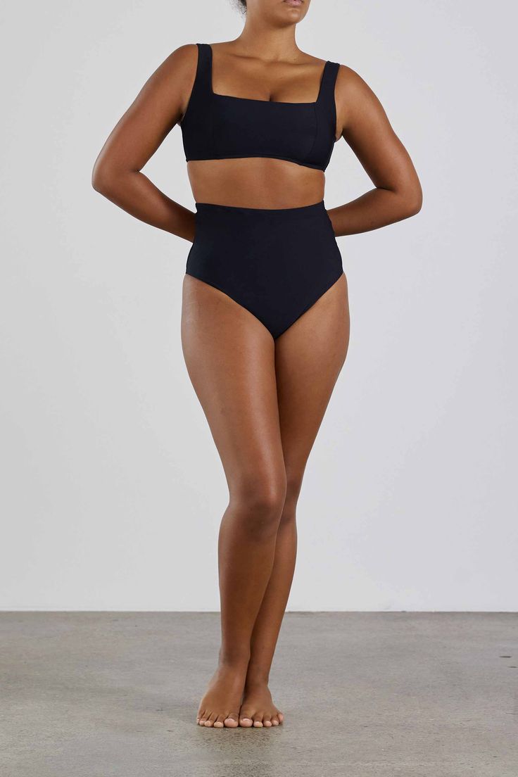 The Lola Bikini Top in Black is chic and understated. Designed to flatter and support the bust it is made using our technically advanced Sculpteur® fabric. With a minimal, square neckline and comfortable wide shoulder straps to provide extra support for larger busts, the top features panels and removable bra cups to enhance and define the bust's profile. Part of our Signature Collection, Lola is supremely comfortable, elegant and flattering for the ultimate in body confidence. Perfect for cup si Black Sculpting Shapewear Swimwear, Compressive High Waist Bra-friendly Swimwear, Compressive High-waist Swimwear Bra Friendly, Compressive High-waist Bra-friendly Swimwear, Black Seamless Sculpting Swimwear, Black Sculpting Seamless Swimwear, Sculpting Elastane Swimwear For Swimming, Sculpting Swimwear Made Of Elastane, Seamless Bandeau Shapewear Swimwear