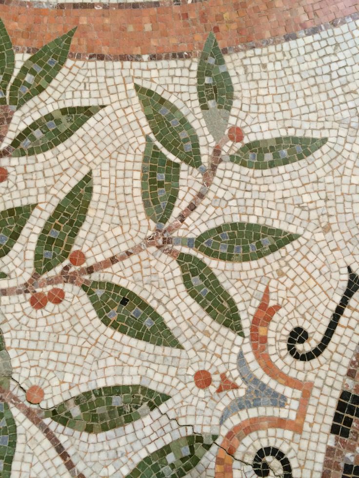 an artistic tile work with leaves and swirls on the bottom part of the floor