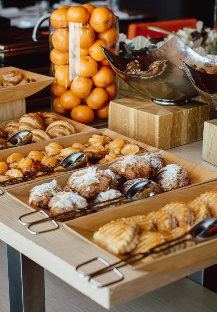 an assortment of pastries and oranges on display