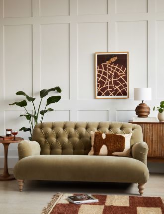 a living room filled with furniture and a painting on the wall