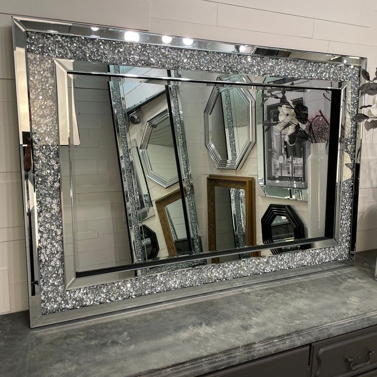 a large mirror sitting on top of a counter