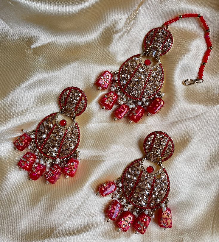 This maangtikka set comes with matching statement earrings and is beautiful and elegant for any occasion. The design is unique and the bright colors can match with anything. Limited prices in each color so grab yours now. Perfect for the festive season during holidays, navratri, and diwali. Festive Chandbali Jewelry Set With Mirror Work, Tilla Tikka For Eid Festivities, Festive Tikka With Latkans For Eid, Traditional Silver Anarkali Set For Party, Eid Festive Tikka With Tilla Detail, Festive Tilla Tikka For Eid, Bollywood Style Tikka For Navratri Festive, Bollywood Jewelry Sets With Mirror Work For Festive Season, Festive Bollywood Tikka With Latkans